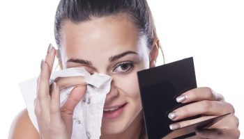 nice beautiful girl removes her make-up using wet wipes