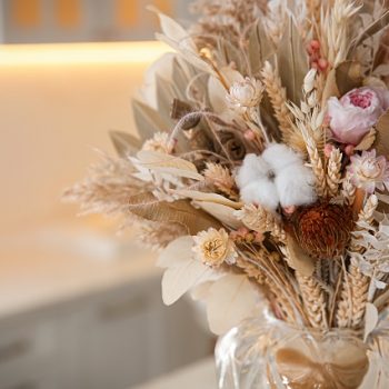 Bouquet of dry flowers and leaves in kitchen. Space for text
