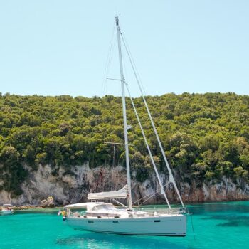 White yacht sailing in the turquoise lagoon on a sunny day